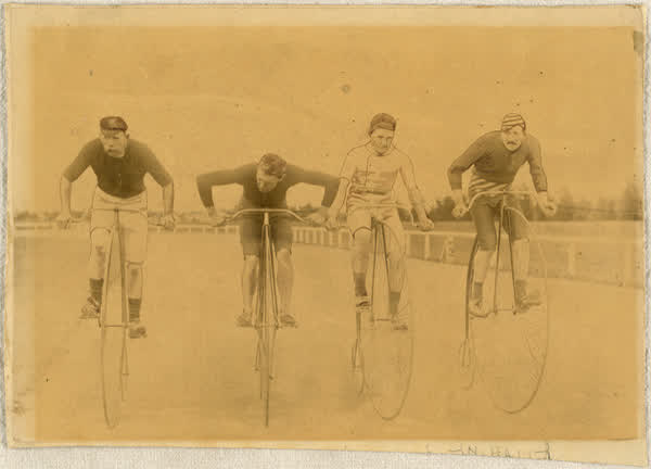 Four men on penny-farthings at Lancaster Park, 1890