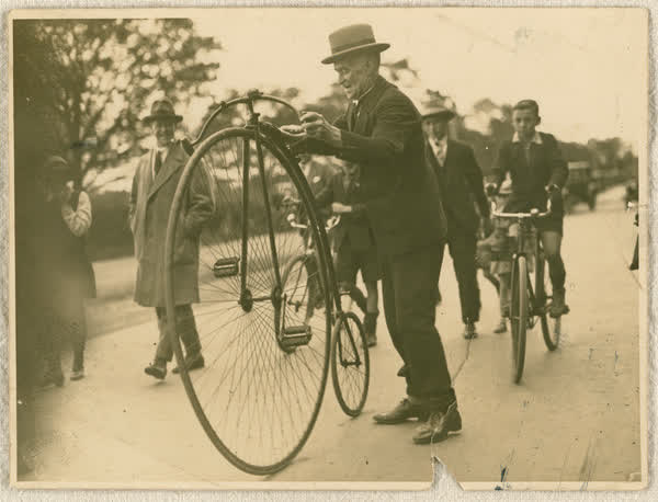 Unidentified man with a penny-farthing, 1920