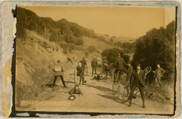 Thirteen unidentified men mounting the hill to Akaroa, 1886