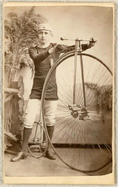 Alfred Ernest Preece holding a penny-farthing, 1882