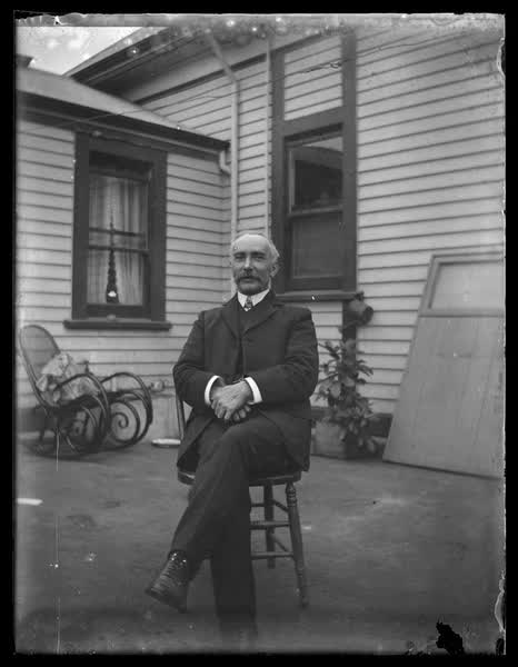 Man outside a weatherboard house, 1900