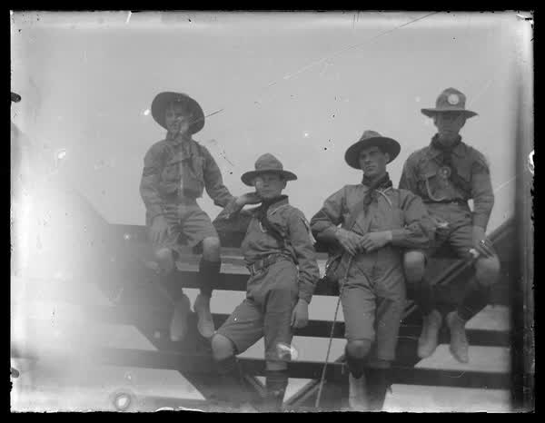 Scouts by a gate, 1900
