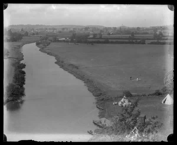 People camping by the river, 1900
