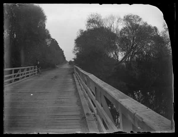 Cyclist on a bridge, 1900