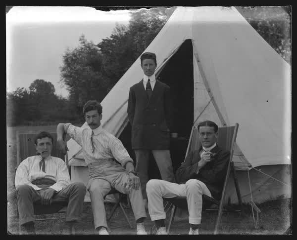 Smoking by the tent, 1900