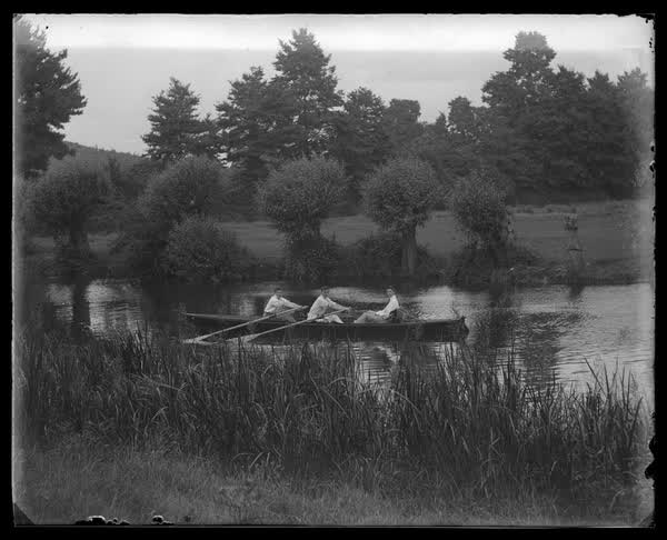 Rowing a row boat on a river, 1900