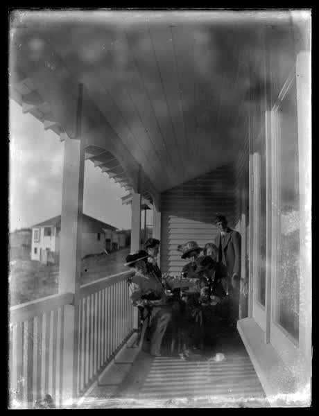Family outside a weatherboard house, 1900