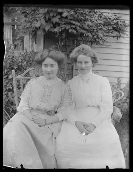 Portrait of two women in a backyard, 1900