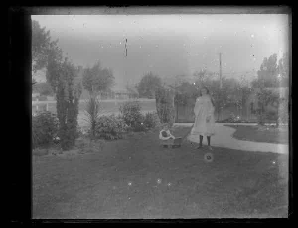 Girl and child playing, 1900