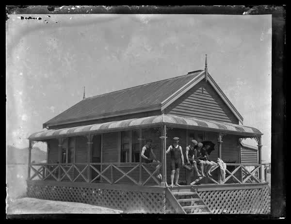 Men on the verandah of weatherboard house, 1900
