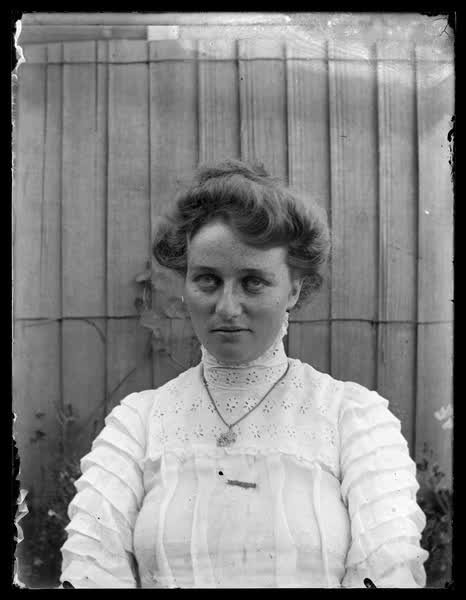 Young woman wearing a necklace, 1900