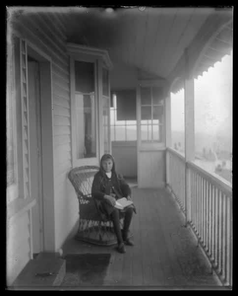 Young girl sitting on the verandah, 1900