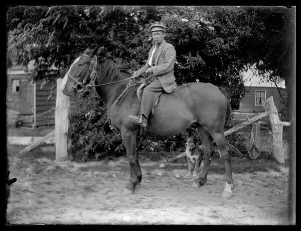 A man on a horse with a dog, 1900