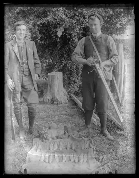 Two boys with rifles, 1900