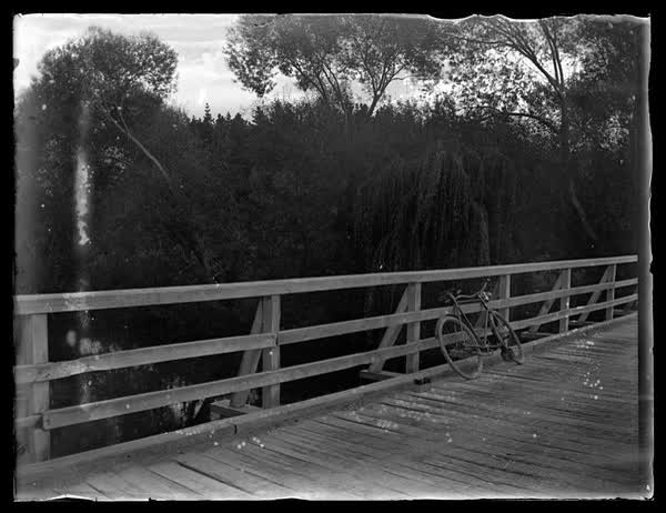 Bicycle on a wooden bridge, 1900