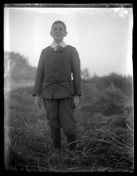 Young boy in a field, 1900