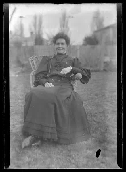 Woman sitting in a garden, 1900