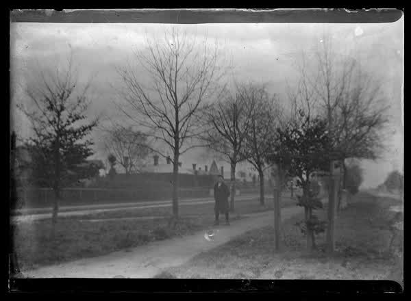 A man walking down a street, 1900