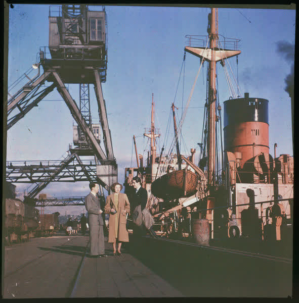 Three people on a wharf, 1950