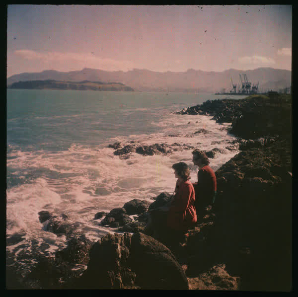 Two women sitting on rocks, 1950