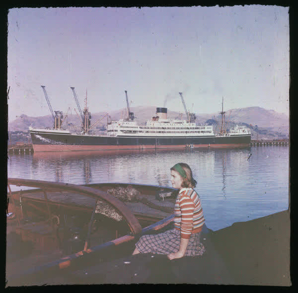 Woman sitting on the Lyttelton Wharf, 1950