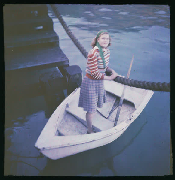 Woman standing in a dinghy, 1950