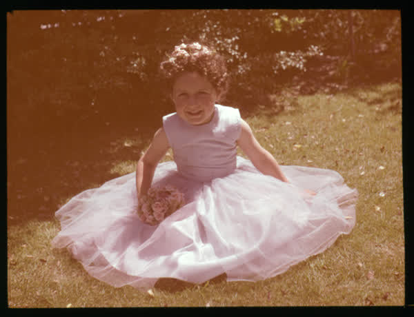 Girl sitting on a lawn, 1950