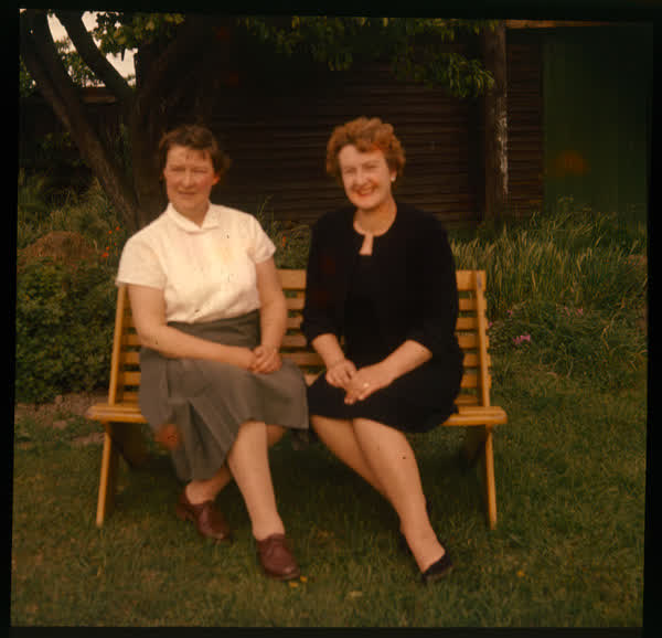 Two women sitting on bench, 1950