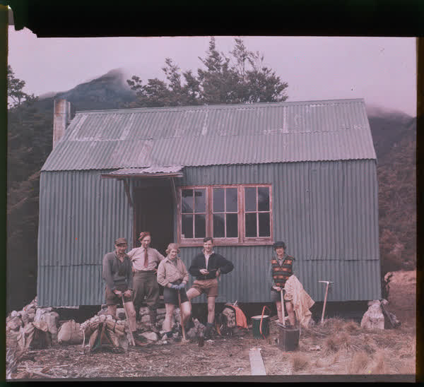 Five people standing in front of Anti Crow Hut, 1950