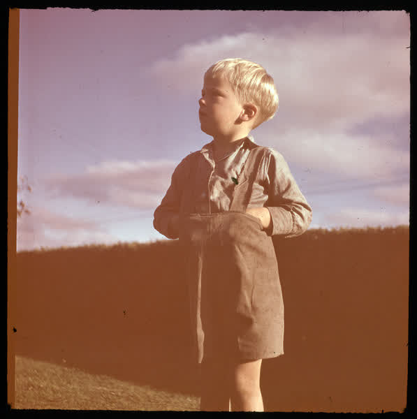 Boy standing in dungarees, 1950
