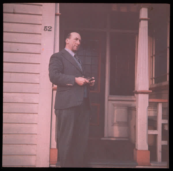 Alexander Wildey standing outside a house, 1940