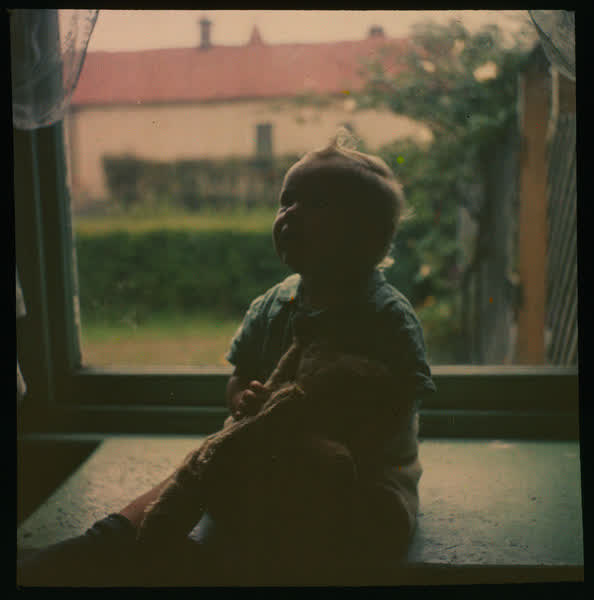 Baby holding a stuffed toy, 1950