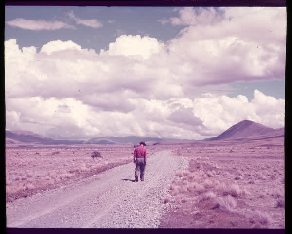 A man walking on a gravel road, 1950