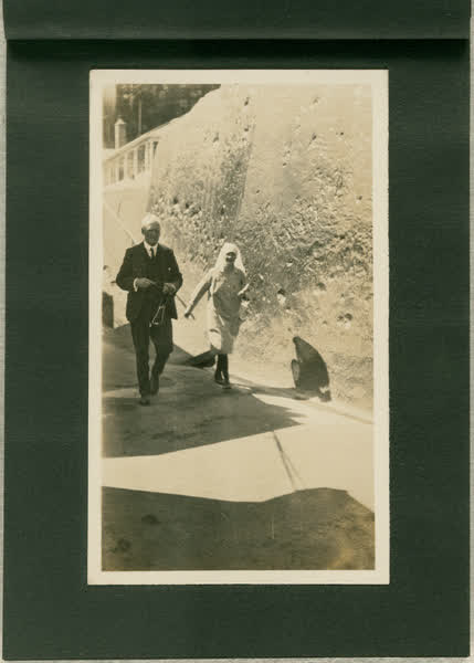 Dr Blackmore walking with nurse outdoors, 1913