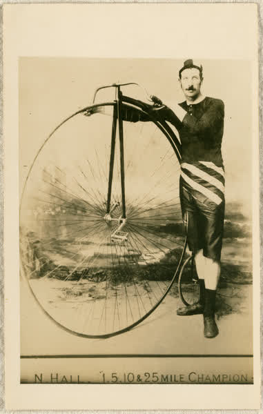 Nat Hall holding a penny-farthing, 1890