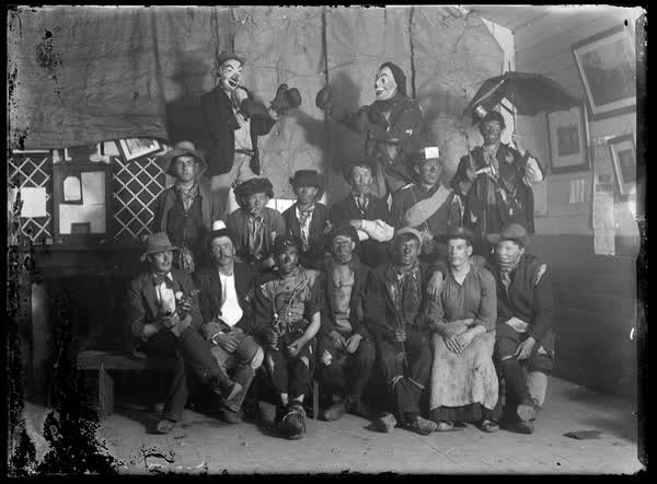 Fifteen men in costume, 1900