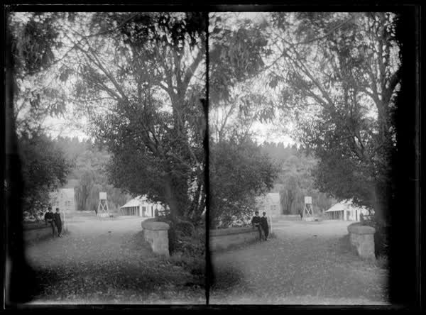 Two boys sitting on fence at the Old Stone House, 1900