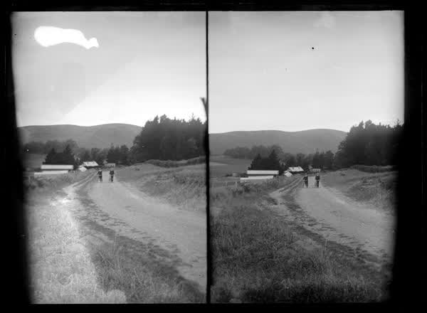 Two men walking bicycles, 1900