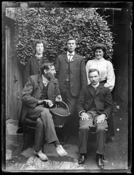 Group portrait with a bucket and bottle, 1910
