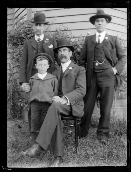 Group portrait of men and a boy, 1900