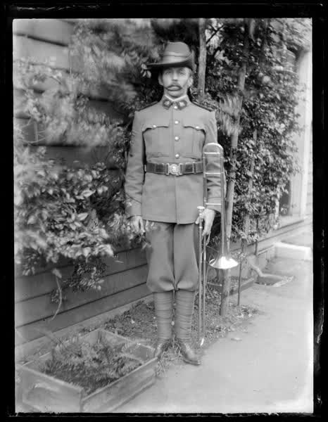 Man in uniform with a trombone, 1910
