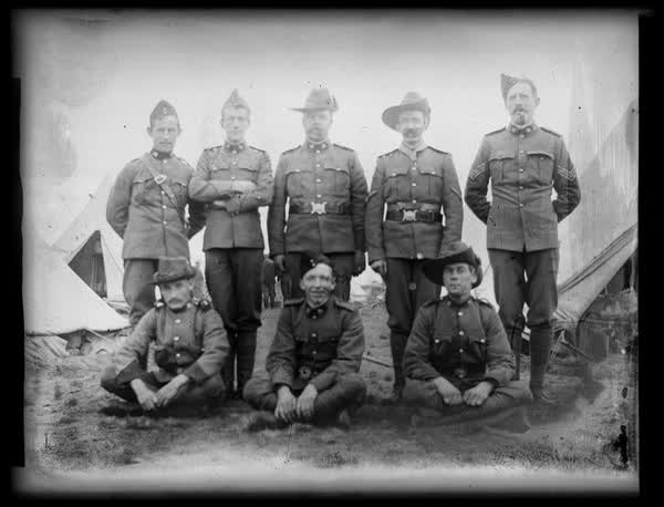 Eight men in uniform, 1910