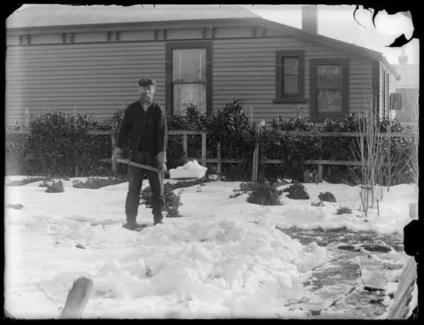 John Sutton shovelling snow, 1900