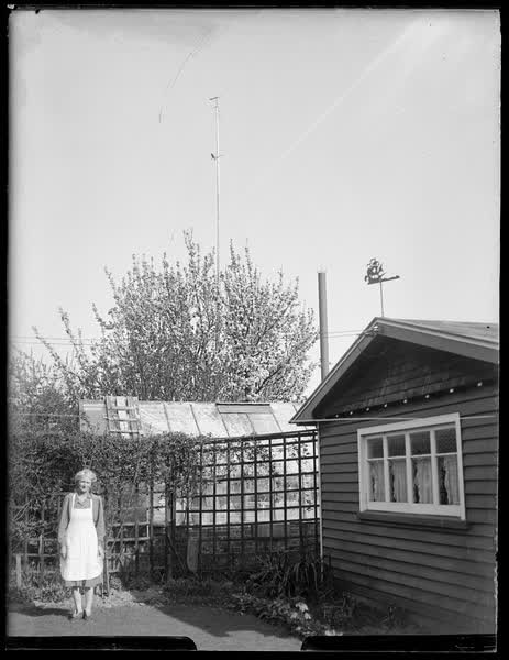 Ruth Sutton standing in a yard, 1950