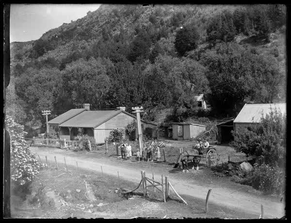 People outside a homestead, 1900