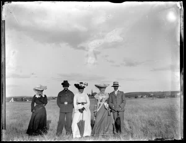 Two men and three women in a paddock, 1900