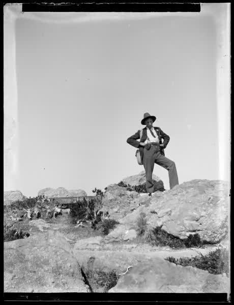 Man standing on a rock, 1900
