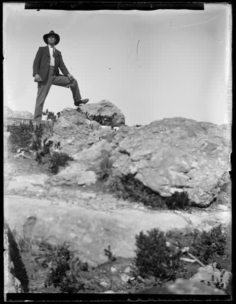 Man standing on a rock, 1900