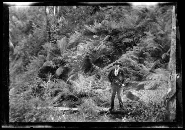 Man standing on a log, 1900