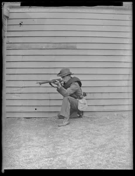 Man pointing a gun, 1900